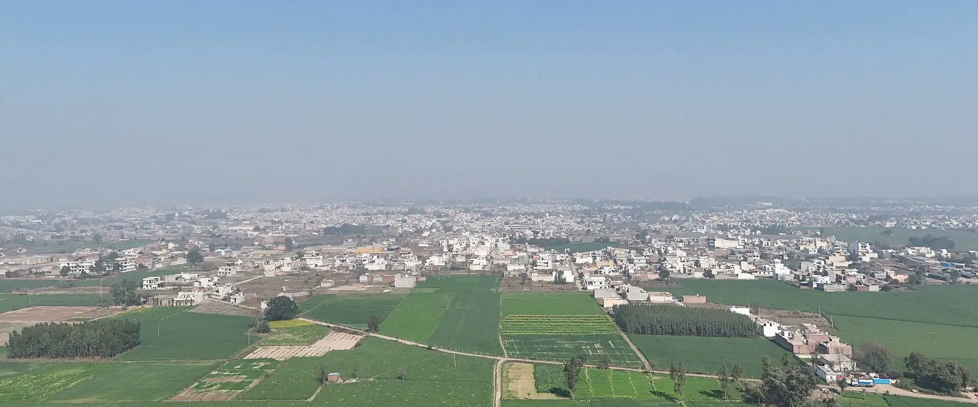 An overview of Said Kheri village in Patiala district, showing the village settlement and its green fields